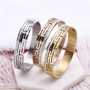Three-tone stainless steel Greek Key bracelets with rhinestones on marble base
