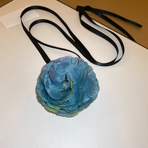 Detail of blue and purple gradient fabric camellia choker with black ribbon tie strap