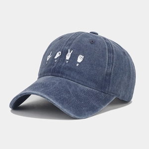 Macro detail of washed cotton baseball cap featuring LOVE sign language embroidery