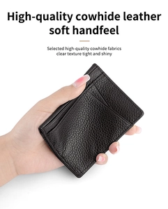 Detail of high-quality black cowhide card holder with soft texture held in hand