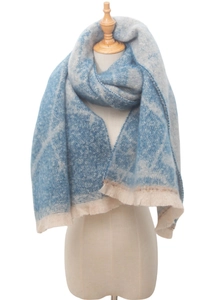 Detail shot of the blue and white gradient woven texture and fringe trim on the scarf