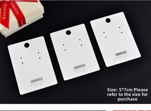 Close-up of 5x7cm white cardboard jewelry display cards for earrings and necklaces