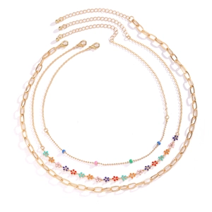 Detail of three-layer gold necklace featuring colorful drip oil flowers and beads
