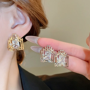 Detail of vintage gold window-frame earrings with square zircon and crystal accents