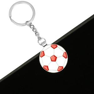 Detail of red and white enamel football pendant on silver metal keychain accessory