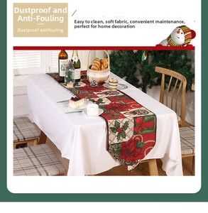 Detail of Christmas table runner with red poinsettia and green holly leaf festive patterns