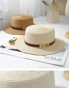 Detail of premium straw sun hat showing woven texture and leather band with gold buckle