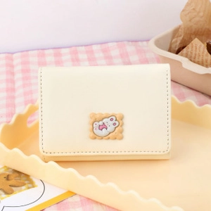 Detail of a beige PU leather mini wallet featuring a cute cookie-shaped 3D bunny ornament