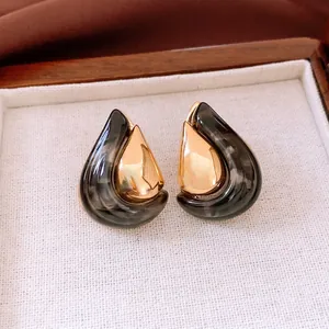 18K gold plated resin teardrop earrings with marble pattern in a wooden jewelry box