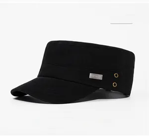 Detail of black cotton military cap showing metal brand logo and golden air vents