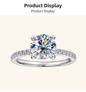 Close-up of a 2-carat round moissanite ring with four-prong setting and side accents