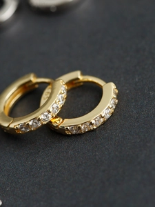 Macro shot of S925 hallmark on gold-plated sterling silver hoop earrings with zircon