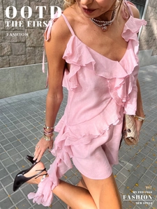 Detail of pink ruffled summer top with tie shoulder straps and flowing layered texture