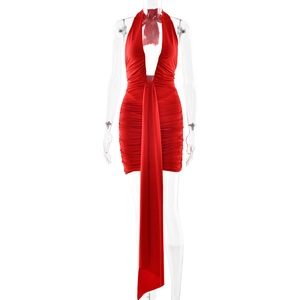 Detail of red halter neck dress with deep V-neck and long elegant waist streamer