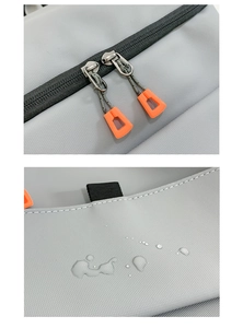 Close-up of waterproof grey Oxford fabric and vibrant orange decorative zippers on the backpack