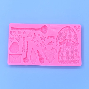 Pink silicone mold featuring Christmas gnomes, trees and snowflakes for DIY baking