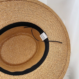 Detail of internal weave and 100% paper material label inside the flat top straw hat