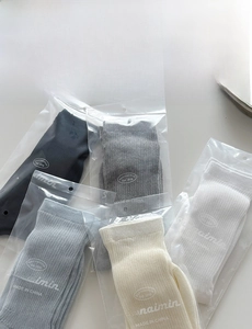 Detail view of multi-color ribbed cotton crew socks in individual brand packaging