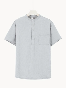 Detail of light grey waffle knit polo shirt with three-button placket and chest pocket