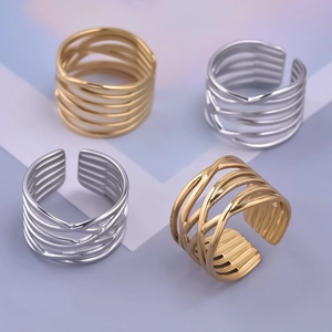Detail of woven cross-line rings in gold and silver finish with adjustable open band