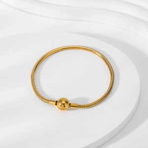 Detail of 18K gold-plated snake bone chain bracelet with round polished clasp