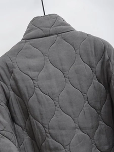 Close-up of wave-quilted pattern and standing collar on this gray winter cotton jacket