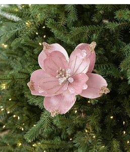 Close-up of pink fabric Christmas flower with gold glitter edges and bead center details