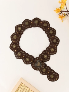 Detailed macro view of vintage heart-shaped leather belt with rivets and embossed star decor