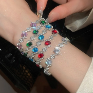 Macro shot of oval cubic zirconia bracelets with colorful gemstones and wave-shaped settings