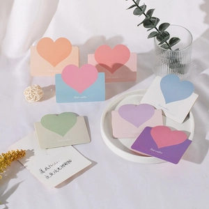 Close-up of heart-shaped greeting cards in pastel colors with Best Wishes gold foil text