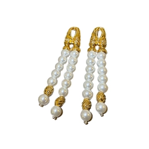 Elegant gold double tassel drop earrings with white faux pearls in a vintage palace style