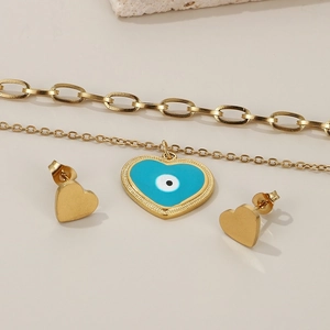 Detail of gold double-layer necklace with blue heart evil eye pendant and matching earrings
