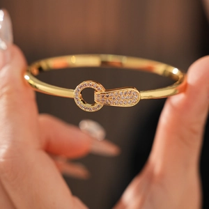 Detail of gold plated round buckle bracelet with micro-paved sparkling cubic zirconia