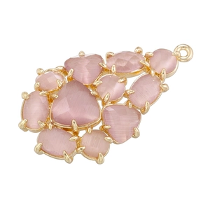 Detailed shot of pink cat eye stones set in a grape-shaped gold leaf pendant