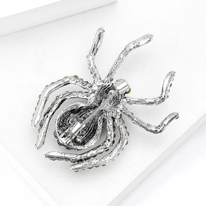 Macro detail of the silver vintage spider brooch back with safety pin closure