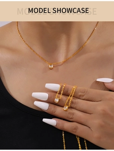 Detailed model shot of gold oval zircon pendant necklace with delicate chain links