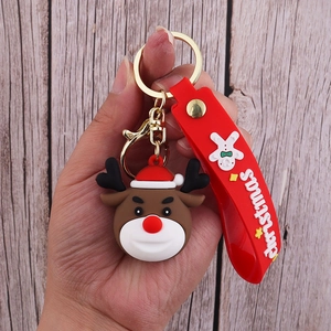 Detailed view of a Christmas reindeer PVC keychain with red silicone strap and gold ring