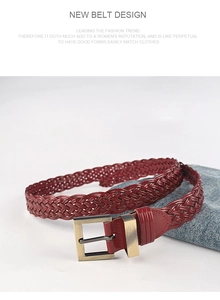 Close-up of a dark red woven belt with a vintage gold square buckle against denim fabric
