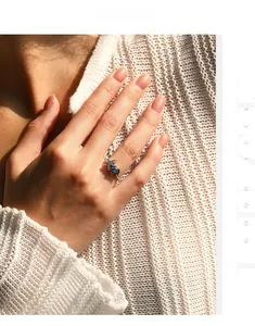 Close-up of S925 sterling silver starfish ring with oval blue gem and tiny diamonds