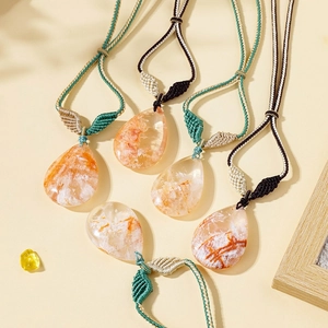 Macro view of five teardrop crystal pendants with natural inclusions on woven cords