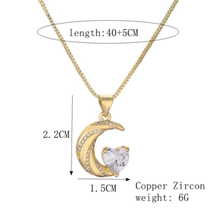Detailed view of gold heart and moon pendant with copper zircon and length specifications