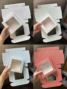 Detail view of paper gift boxes with transparent windows in various patterns and colors