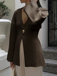 Detail of elegant dark brown V-neck knit cardigan with a single button and loose sleeves