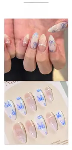 Detailed view of blue bow almond press-on nails with white lace and pearl accents