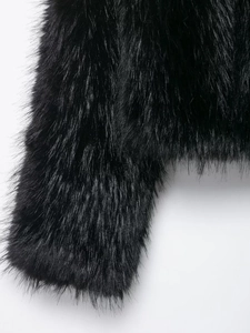 Detailed close-up showing soft texture and rich fibers of the black faux fur jacket