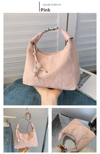 Pink dumpling bag featuring crinkled texture, metallic buckle, and clear bead details