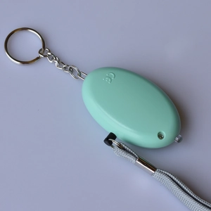 Mint green personal safety alarm with LED light, metal keychain and braided lanyard strap