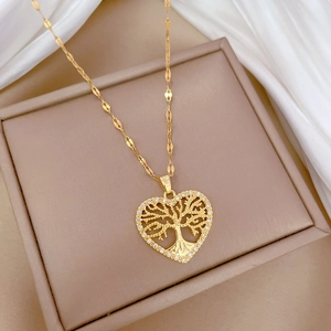 Detail showing a gold heart pendant with tree of life design and micro-pave crystals