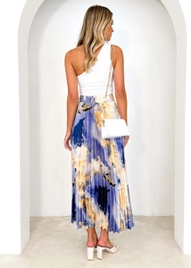 Rear view of a model in a high-waisted pleated midi skirt with blue oil painting print
