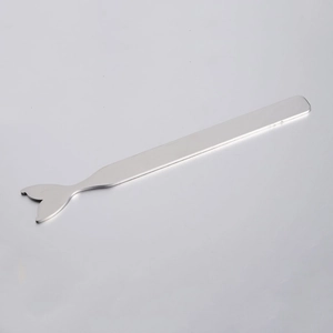 Macro shot of silver stainless steel mermaid tail tool with polished mirror finish surface
